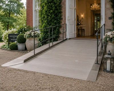 A ramped, step-free entrance with handrails leading up to a venue's main door.