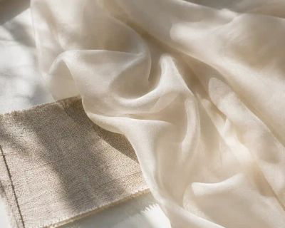 Lightweight silk chiffon fabric draped and catching natural light.