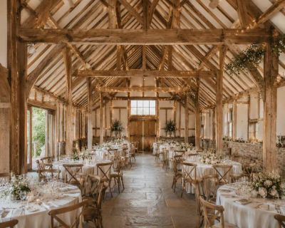 The exposed wooden beams of a barn-style wedding venue interior.