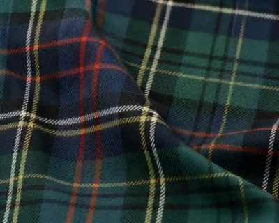 A close-up of tartan fabric, evoking Highland Scottish wedding dress.