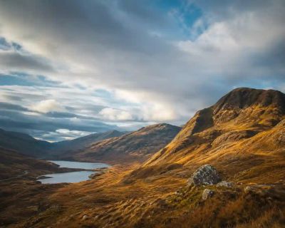 Dramatic Scottish Highland hills under a wide sky.
