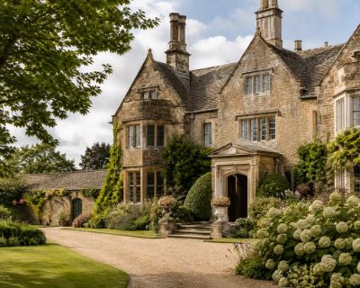 The stone exterior of a historic country house with a garden ceremony space.